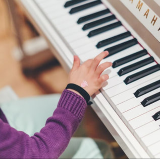 Child practicing piano.