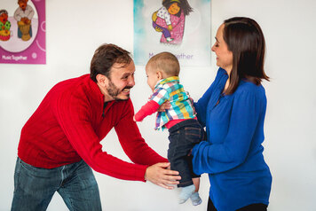 Mom and Dad dance with their baby in Music Together class.